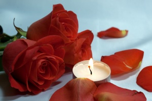 Romantic  night . bed , roses  and  , petals candles.